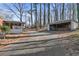 View of the back of the property highlighting the sunroom and detached garage in a wooded setting at 162 Fairburn Sw Rd, Atlanta, GA 30331