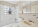 Traditional bathroom with tiled shower/tub, window, commode, and single sink vanity with medicine cabinet and lighting at 162 Fairburn Sw Rd, Atlanta, GA 30331