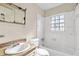 Bathroom with a vanity, mirror, bathtub and window at 162 Fairburn Sw Rd, Atlanta, GA 30331