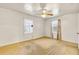 Neutral bedroom featuring carpet, ceiling fan and single windows for natural light at 162 Fairburn Sw Rd, Atlanta, GA 30331