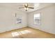 Bright bedroom featuring neutral carpet, ceiling fan, and single windows at 162 Fairburn Sw Rd, Atlanta, GA 30331