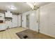 Compact kitchen featuring neutral flooring, white cabinets and traditional chandelier at 162 Fairburn Sw Rd, Atlanta, GA 30331