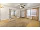 Sunlit living room featuring open doorways, tan carpet and neutral window treatments at 162 Fairburn Sw Rd, Atlanta, GA 30331