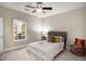 Bright bedroom featuring carpet, neutral paint, and a large window for lots of natural light at 305 Deep Step Rd, Covington, GA 30014