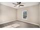 Neutral bedroom with a ceiling fan and a window letting in natural light at 305 Deep Step Rd, Covington, GA 30014