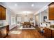 Open-concept dining area with hardwood floors, a modern chandelier, and ample natural light at 305 Deep Step Rd, Covington, GA 30014