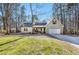 Charming home with an attached garage and well-manicured lawn and mature trees in the front yard at 305 Deep Step Rd, Covington, GA 30014