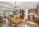 Open-concept kitchen and dining area featuring a wooden table and stainless steel appliances at 305 Deep Step Rd, Covington, GA 30014