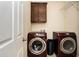 Laundry room equipped with modern washer and dryer, with white door at 305 Deep Step Rd, Covington, GA 30014