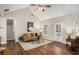 Cozy living room with hardwood floors, a comfortable couch, and a staircase at 305 Deep Step Rd, Covington, GA 30014