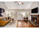 Inviting living room featuring a cozy fireplace, hardwood flooring, and a comfortable leather couch at 305 Deep Step Rd, Covington, GA 30014