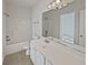 Bathroom with white cabinets, single sink, and shower/bath combo at 5692 Greensage Dr, Atlanta, GA 30349