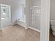 Well-lit bathroom featuring a soaking tub, glass shower, and tile floors at 5692 Greensage Dr, Atlanta, GA 30349