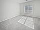 Bright and airy bedroom with plush carpet, large window, and neutral paint at 5692 Greensage Dr, Atlanta, GA 30349