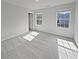 Bright bedroom with two windows and neutral carpet; a serene and inviting space at 5692 Greensage Dr, Atlanta, GA 30349