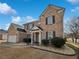 Charming two-story brick home with attached two car garage, and manicured front yard at 5692 Greensage Dr, Atlanta, GA 30349