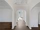 Bright foyer features arched doorways, dark wood floors, and neutral paint color at 5692 Greensage Dr, Atlanta, GA 30349