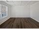 Living room with large window, dark floors, and white walls at 5692 Greensage Dr, Atlanta, GA 30349