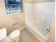 Bathroom featuring a toilet and tub/shower combination with light-colored walls and tile flooring at 949 Bobcat Se Ct, Marietta, GA 30067