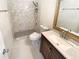 Bathroom featuring a tiled shower, modern vanity, and marble countertops at 949 Bobcat Se Ct, Marietta, GA 30067