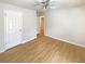 Bedroom with light-colored walls, wood-look flooring, a ceiling fan, and access to a hallway at 949 Bobcat Se Ct, Marietta, GA 30067