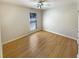 Bedroom features light-colored walls, wood-look flooring, a ceiling fan, and a window for natural light at 949 Bobcat Se Ct, Marietta, GA 30067