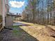 Lawn of the private backyard showing the deck, patio, and wooded perimeter at 1090 Fountain Head Ln, Lawrenceville, GA 30043