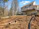 Backyard view featuring a walkout basement, elevated deck and fire pit at 1090 Fountain Head Ln, Lawrenceville, GA 30043