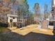 Spacious backyard featuring a playhouse, swing set, and deck with stairs at 1090 Fountain Head Ln, Lawrenceville, GA 30043