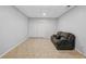 An unfinished area of the basement includes a couch and tile floors at 1090 Fountain Head Ln, Lawrenceville, GA 30043