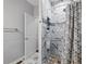Modern bathroom featuring a walk-in shower with marble tile and a stylish shower curtain at 1090 Fountain Head Ln, Lawrenceville, GA 30043