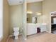 Bathroom with double vanity, large mirror, shower and tub with window at 1090 Fountain Head Ln, Lawrenceville, GA 30043
