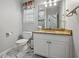 Neat half-bathroom with granite countertop, modern fixtures, and marble floors at 1090 Fountain Head Ln, Lawrenceville, GA 30043