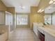 Bathroom with double vanity, large mirror, shower and tub with window at 1090 Fountain Head Ln, Lawrenceville, GA 30043