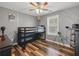 Well-lit bedroom with a modern bunkbed, neutral walls, and rich hardwood flooring at 1090 Fountain Head Ln, Lawrenceville, GA 30043