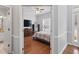 Cozy bedroom with a ceiling fan, hardwood floors, and a large window at 1090 Fountain Head Ln, Lawrenceville, GA 30043