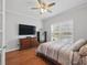Comfortable bedroom with a ceiling fan, hardwood floors, and a large window at 1090 Fountain Head Ln, Lawrenceville, GA 30043