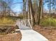 Picturesque bridge along a walking path with a metal railing offering access to the community's natural beauty at 1090 Fountain Head Ln, Lawrenceville, GA 30043