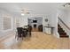 Dining area next to staircase features a wooden table and tiled floor at 1090 Fountain Head Ln, Lawrenceville, GA 30043