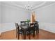 Formal dining room with hardwood floors, wainscoting, and a stylish chandelier at 1090 Fountain Head Ln, Lawrenceville, GA 30043