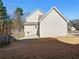 View of the home's side elevation, fence, deck, and landscaped yard at 1090 Fountain Head Ln, Lawrenceville, GA 30043