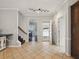 Inviting foyer featuring tile flooring, neutral walls, staircase, and access to the dining room and front door at 1090 Fountain Head Ln, Lawrenceville, GA 30043