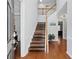 Inviting foyer with hardwood floors and a staircase leading to the upper level at 1090 Fountain Head Ln, Lawrenceville, GA 30043