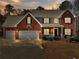 Charming two-story home with brick facade, manicured landscaping, and a two-car garage at 1090 Fountain Head Ln, Lawrenceville, GA 30043