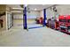 This spacious garage features a vehicle lift and ample storage for tools and equipment at 1090 Fountain Head Ln, Lawrenceville, GA 30043
