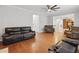 Spacious living room with hardwood floors, leather sofas, and views into the kitchen at 1090 Fountain Head Ln, Lawrenceville, GA 30043