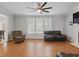 Bright living room with hardwood floors, a ceiling fan, and comfortable seating at 1090 Fountain Head Ln, Lawrenceville, GA 30043