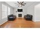 Inviting living room with a fireplace, hardwood floors, and comfortable leather sofas at 1090 Fountain Head Ln, Lawrenceville, GA 30043
