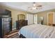 Spacious main bedroom with trey ceiling, hardwood floors, and a glimpse of the ensuite bath and closet at 1090 Fountain Head Ln, Lawrenceville, GA 30043