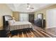 A spacious bedroom features a dark wood bedroom set, ceiling fan, and tray ceiling at 1090 Fountain Head Ln, Lawrenceville, GA 30043